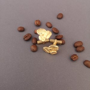 Manschettenknöpfe in form von Kaffeebohnen in Gold.